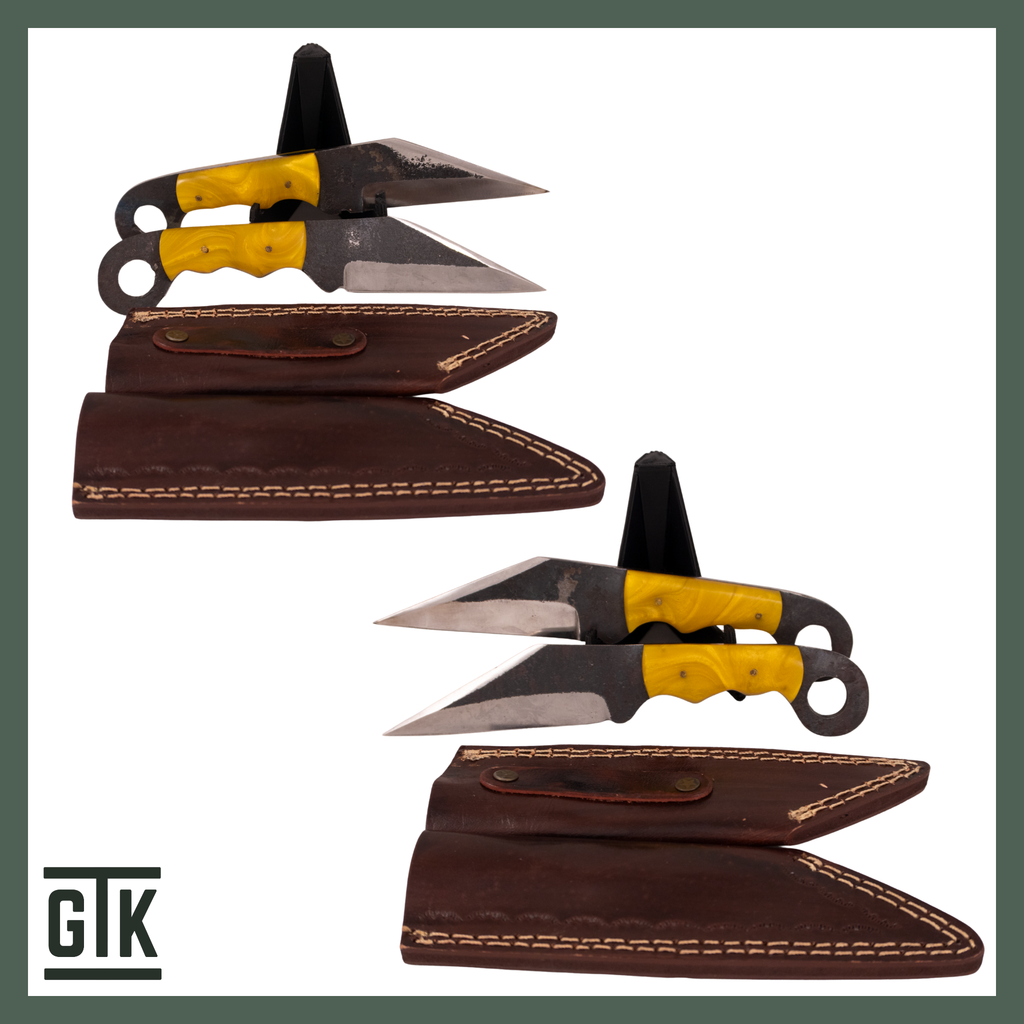 Two matching Yellowstone fixed-blade knives showing yellow resin handle scales, angular blade profiles, polished bevels, and oversized steel handle rings.